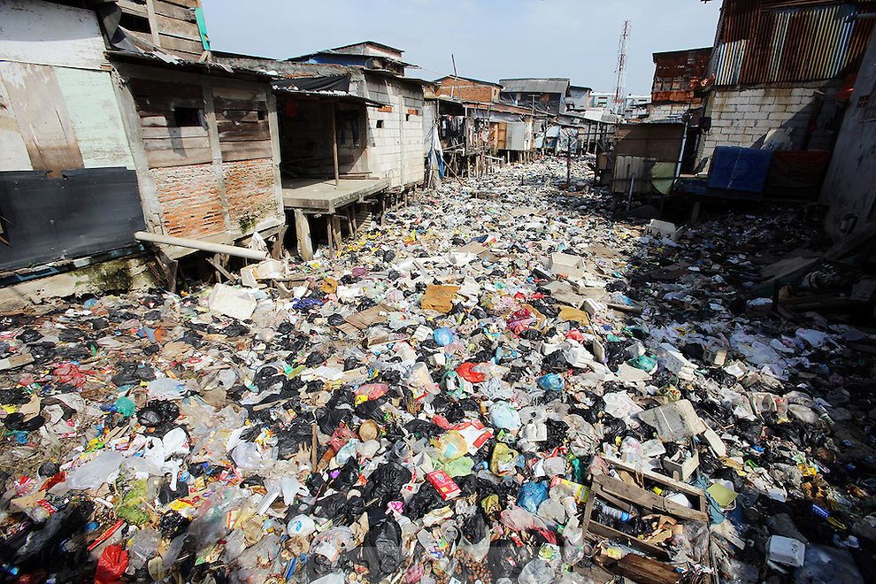 a slum area with canal full of trashes